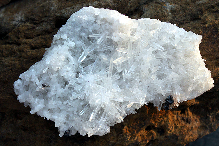 small crystals (silver) of Hbnerite in a matrix of quartz