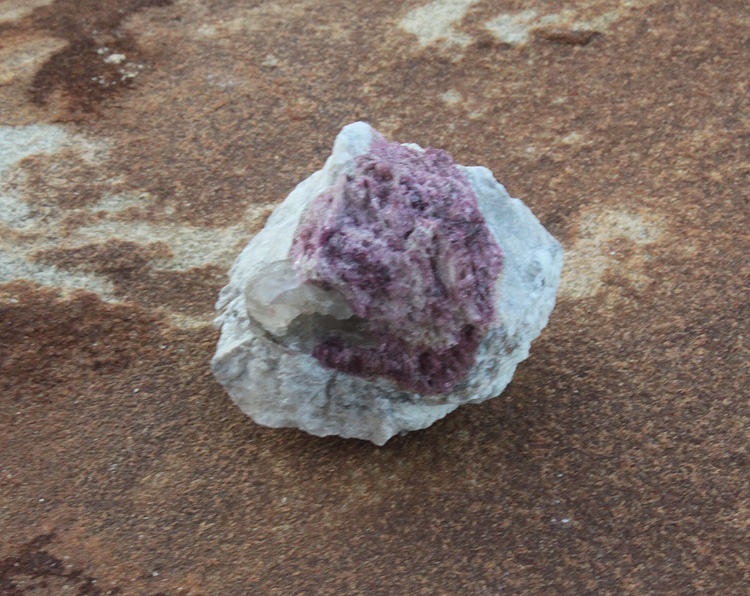 pale green Tourmaline crystal in a purple matrix stone